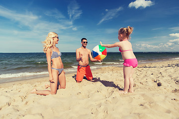 Image showing happy family playing with inflatable ball on beach