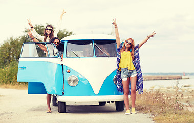 Image showing smiling young hippie friends over minivan car