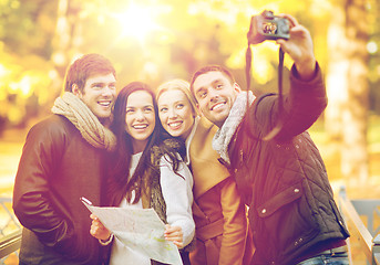 Image showing group of friends with photo camera in autumn park