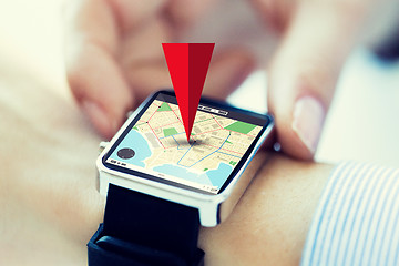 Image showing close up of hands with map on smartwatch screen