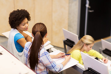Image showing group of students talking in lecture hall