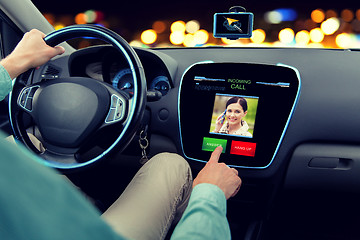 Image showing close up of man driving car and receiving call