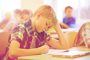 Image showing group of school kids writing test in classroom