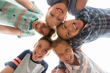 Image showing group of happy children showing tongue in circle