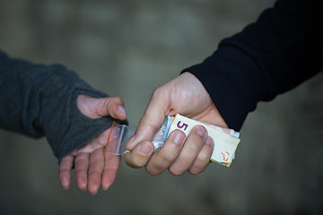 Image showing close up of addict buying dose from drug dealer