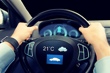 Image showing close up of man driving car with weather sensor