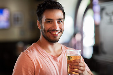 Image showing happy man drinking beer at bar or pub