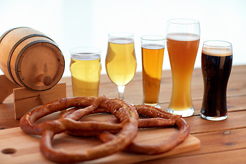 Image showing close up of beer glasses, barrel and pretzels