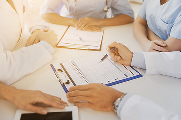 Image showing close up of doctors with clipboards at hospital