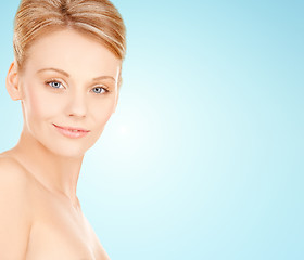 Image showing beautiful young woman face over blue background