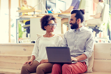 Image showing happy creative team with laptop in office