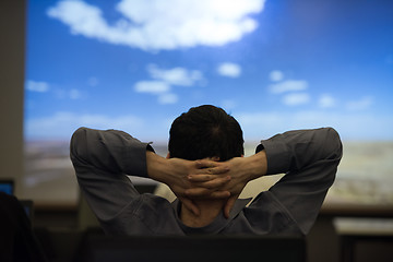 Image showing young man dreaming clouds on presentation