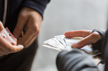 Image showing close up of addict buying dose from drug dealer