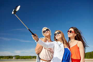 Image showing group of smiling women taking selfie on beach