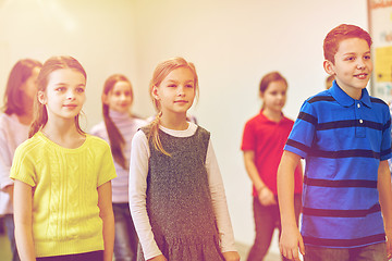 Image showing group of smiling school kids walking in corridor