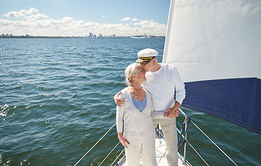 Image showing senior couple kissing on sail boat or yacht in sea