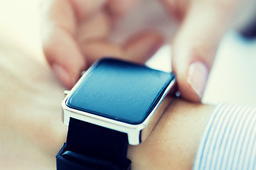 Image showing close up of hands setting smart watch