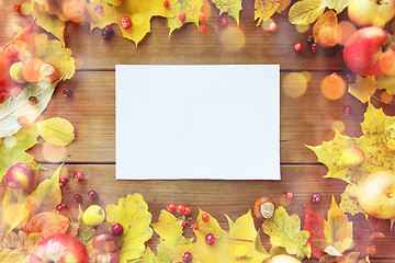 Image showing close up of paper with autumn leaves and fruits