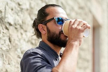 Image showing man drinking coffee from paper cup on street