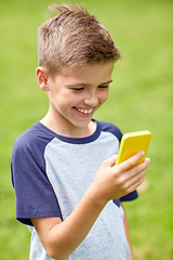 Image showing boy with smartphone playing game in summer park