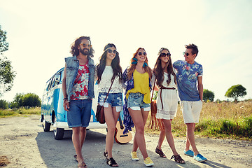 Image showing smiling young hippie friends over minivan car