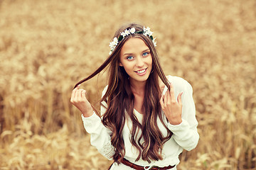 Image showing smiling young hippie woman on cereal field