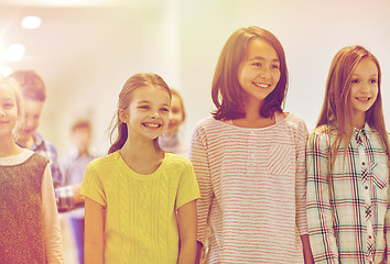 Image showing group of smiling school kids walking in corridor