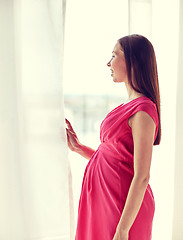 Image showing happy pregnant woman with big tummy at home