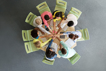 Image showing group of international students with hands on top