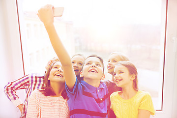 Image showing group of school kids taking selfie with smartphone