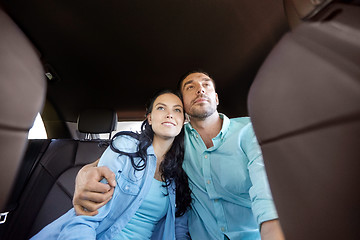 Image showing happy man and woman hugging in car