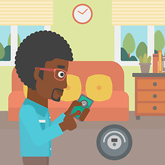 Image showing Man controlling vacuum cleaner with smartphone.