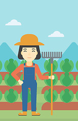 Image showing Female farmer with rake vector illustration.