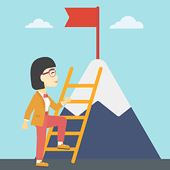 Image showing Business woman climbing on mountain.