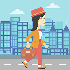 Image showing Successful business woman walking with briefcase.