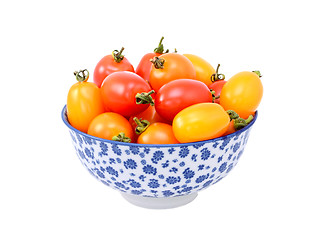Image showing Red and yellow plum tomatoes in a blue and white china bowl