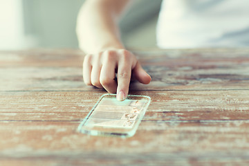 Image showing close up of woman with transparent smartphone