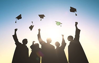 Image showing silhouettes of students throwing mortarboards