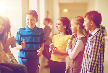 Image showing group of school kids with soda cans in corridor