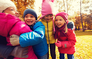 Image showing group of happy children hugging in autumn park