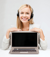 Image showing smiling woman with headset and laptop computer