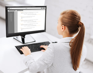 Image showing businesswoman with coding on computer at office