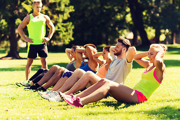 Image showing group of friends or sportsmen exercising outdoors