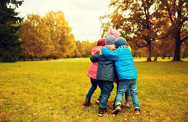 Image showing group of happy children hugging in autumn park