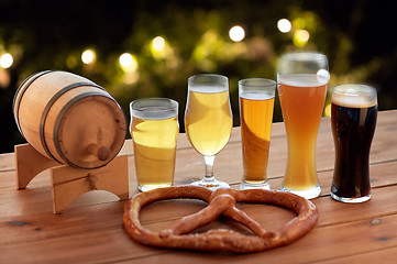 Image showing close up of beer glasses, barrel and pretzel