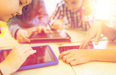 Image showing close up of school kids playing with tablet pc 