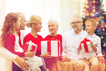 Image showing smiling family with gifts at home