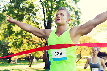 Image showing happy young male runner winning on race finish