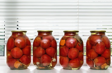 Image showing Canned tomatoes in large glass jars.