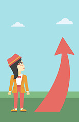 Image showing Business woman looking at arrow going up.